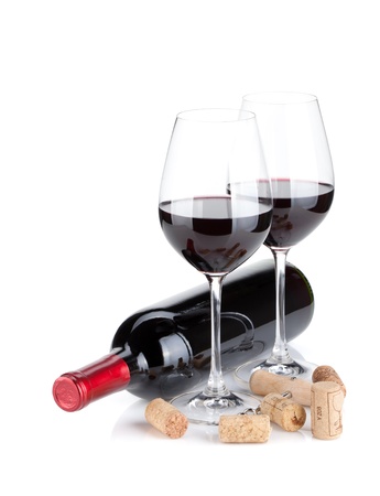 Red wine glasses, bottle and corks. Isolated on white backgroundの写真素材