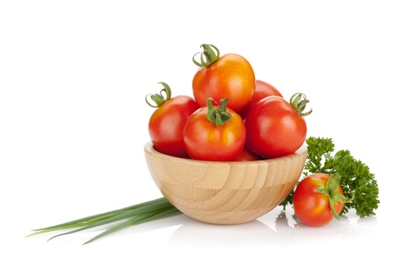 Ripe tomatoes in a bowl, parsley, green onion. Isolated on white backgroundの写真素材