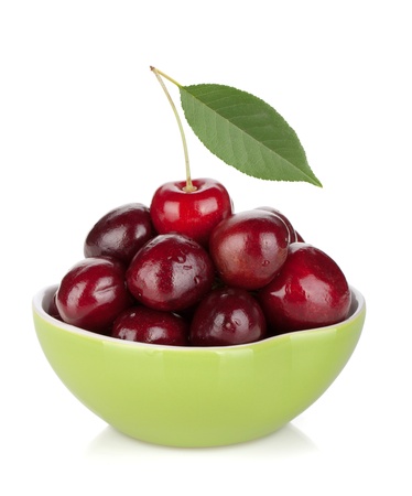 Ripe cherries in a bowl. Isolated on white backgroundの写真素材