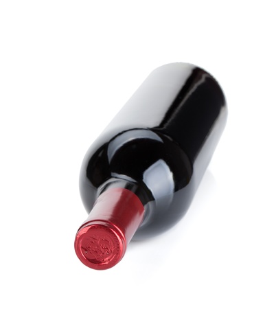 Lying red wine bottle. Small DOF. Isolated on white backgroundの写真素材