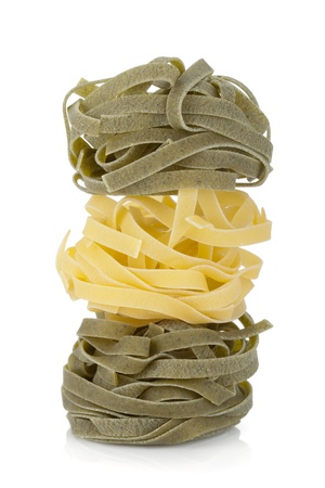 Fettuccine nest colored pasta   Isolated on white backgroundの写真素材
