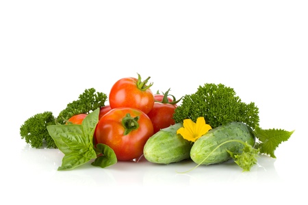 Ripe tomatoes, cucumbers, basil and parsley. Isolated on white backgroundの写真素材