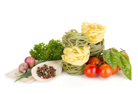 Italian food: pasta, tomatoes, fresh herbs. Isolated on white backgroundの写真素材