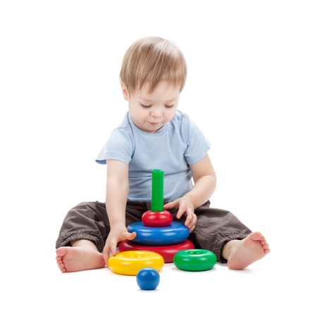 Small baby with a toy pyramid. Isolated on white backgroundの写真素材