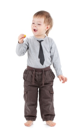 Small baby eating candy. Isolated on white backgroundの写真素材