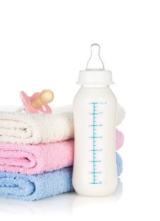 Baby bottle, pacifier and towels. Isolated on white backgroundの写真素材