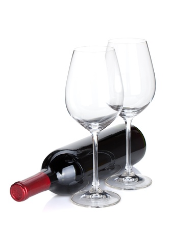 Red wine bottle and empty glasses. Isolated on white backgroundの写真素材
