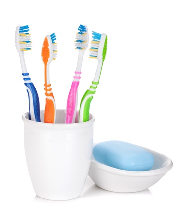 Four colorful toothbrushes and soap. Isolated on white backgroundの写真素材