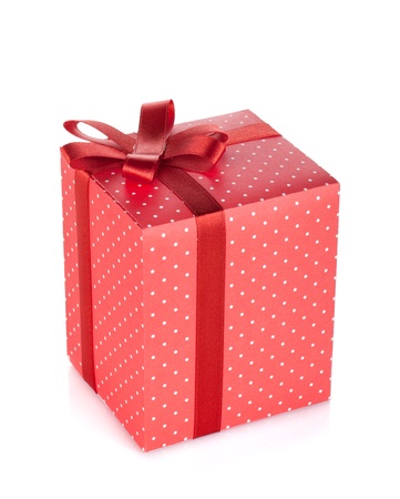 Red gift box with ribbon and bow. Isolated on white backgroundの写真素材
