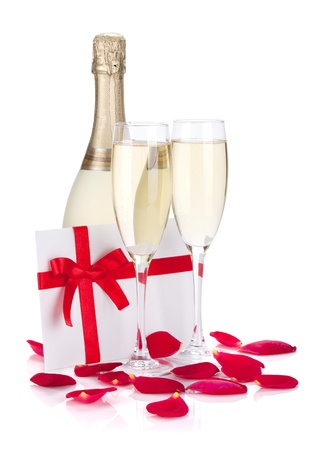 Two champagne glasses, letter and rose petals. Isolated on white backgroundの写真素材
