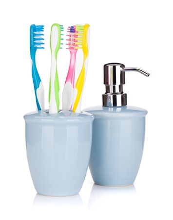 Four colorful toothbrushes and liquid soap. Isolated on white backgroundの写真素材