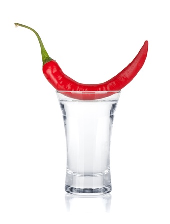 Shot of vodka and red hot chili pepper  Isolated on white backgroundの写真素材