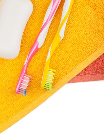 Toothbrushes, soap and two towels. Isolated on white backgroundの写真素材