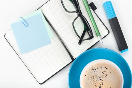 Coffee cup and office supplies closeupの写真素材