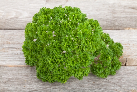 Curly parsley on  wooden tableの写真素材