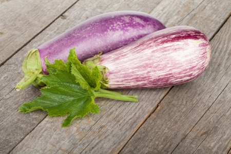 Fresh ripe eggplants on wooden tableの写真素材