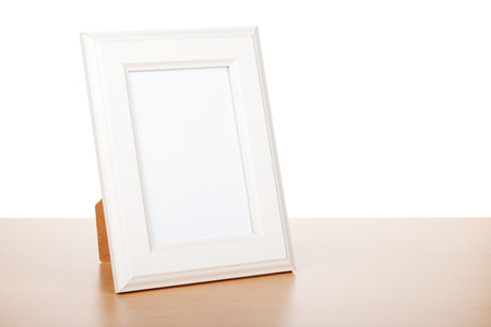 Photo frame on wood table. Isolated on white background