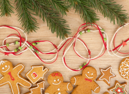 Christmas fir tree and gingerbread cookies on wooden board