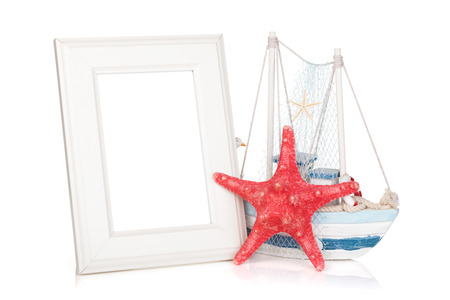Photo frame, starfish and decor boat. Isolated on backgroundの写真素材
