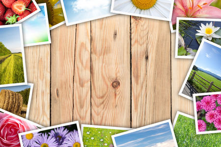 Stack of printed pictures collage on wooden table with copy space for your text or photoの写真素材