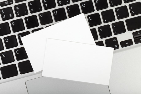 Blank business cards over laptopの写真素材