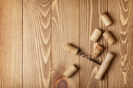 Corkscrew and wine corks on wooden table background with copy spaceの写真素材