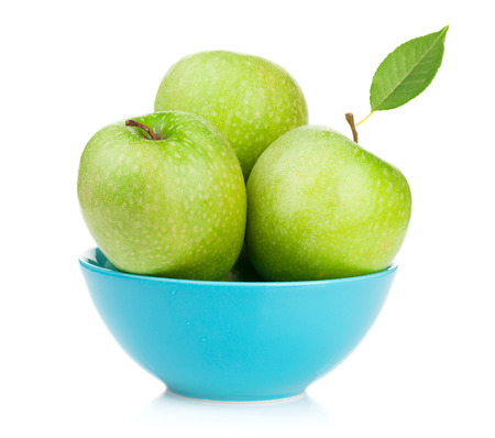 Fresh green apples in bowl. Isolated on white backgroundの写真素材