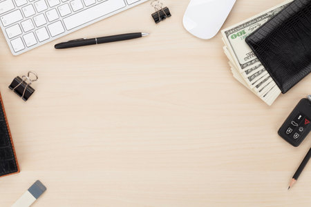 Office table with pc, supplies and money cash. View from above with copy spaceの写真素材