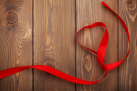 Heart shape ribbon over wood valentines day backgroundの写真素材