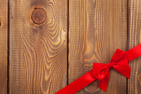 Valentines day background with red ribbon over woodの写真素材