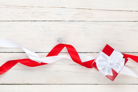 Valentines day background with gift box over white wooden table backgroundの写真素材