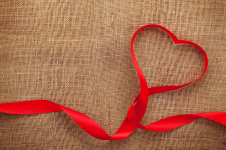 Valentines day heart shaped ribbon over burlap with copy spaceの写真素材