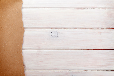 Cardboard paper over white wood background with copy spaceの写真素材