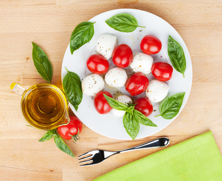 Caprese salad plate on wooden tableの写真素材