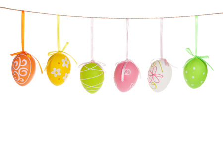 Colorful easter eggs hanging on rope. Isolated on white の写真素材