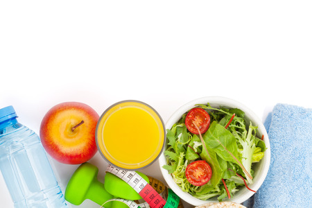 Dumbells, tape measure, healthy food and towels. Fitness and health. Isolated on white backgroundの写真素材