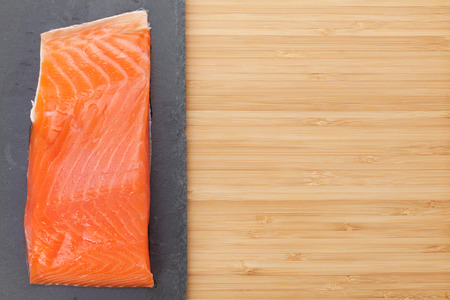 Fresh salmon fish on bamboo wooden table with copy spaceの写真素材