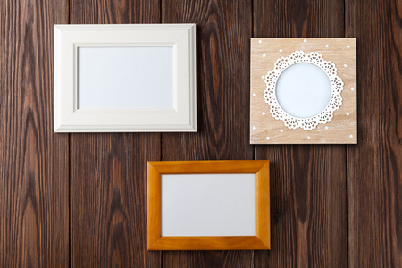 Photo frames on wooden wall with copy space