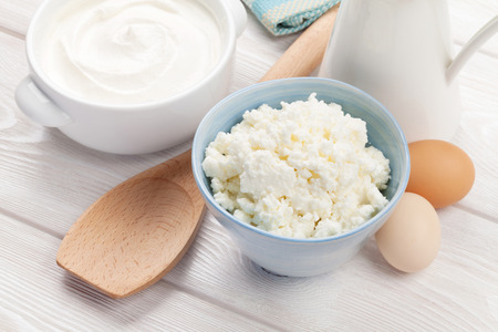 Dairy products on wooden table. Sour cream, milk and cheeseの写真素材