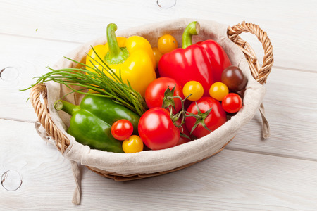 Fresh vegetables basket on wooden tableの写真素材