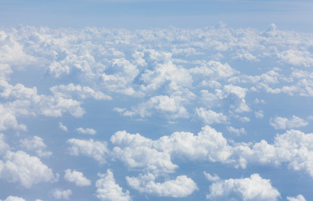 Blue sky with clouds background. View from airplane