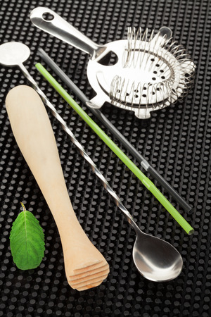 Bar drink accessories over black rubber matの写真素材