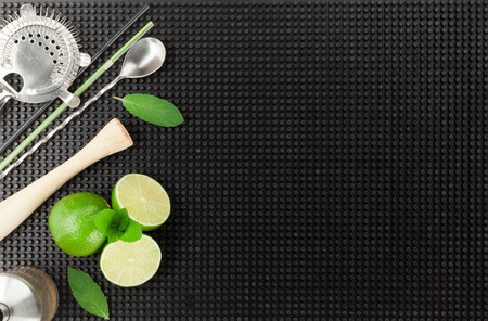 Bar drink accessories over black rubber mat. Top view with copy spaceの写真素材