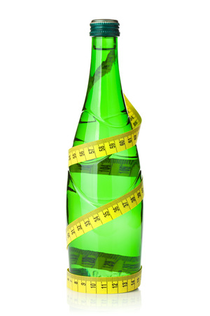 Water bottle with measuring tape. Isolated on white backgroundの写真素材