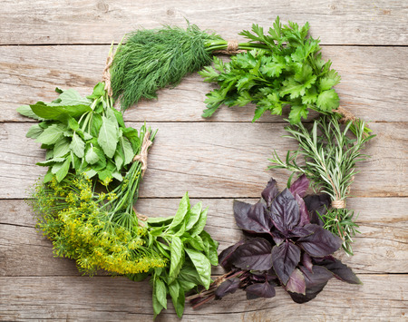 Fresh garden herbs on wooden table. Top view with copy spaceの写真素材