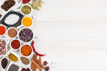 Various spices on white wooden background. Top view with copy spaceの写真素材