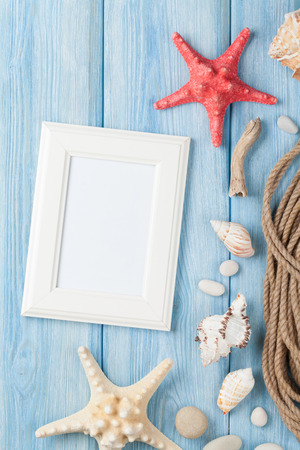 Summer time sea vacation with blank photo frame, star fish and marine ropeの写真素材