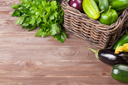 Fresh farmers garden vegetables and herbs on wooden table. View with copy spaceの写真素材