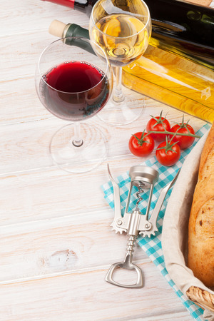 White and red wine, cheese and bread on white wooden table background. の写真素材