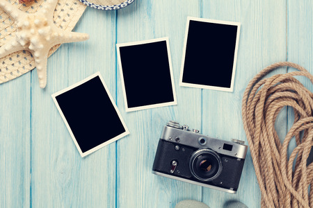 Travel and vacation photo frames and items on wooden table. Top viewの写真素材